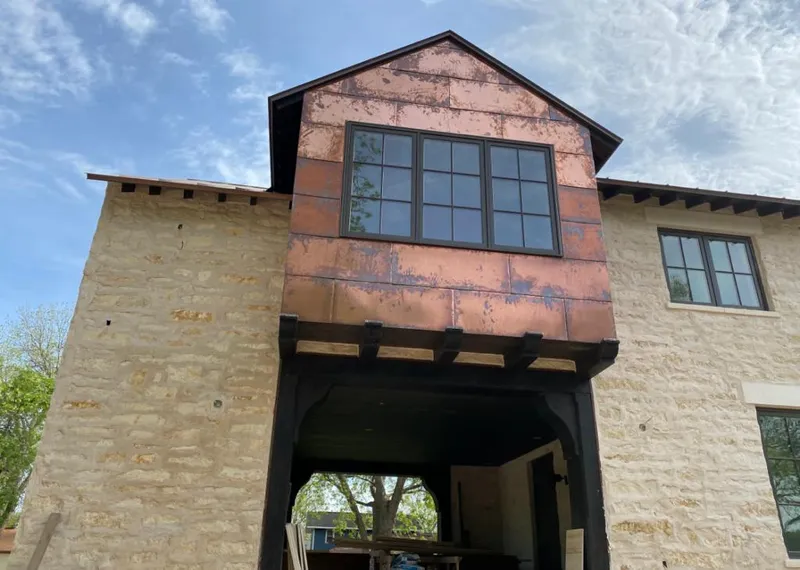Copper metal panel facade on a stone building for Metal Roof Coating in Fargo