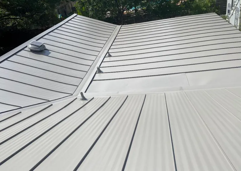 Solar attic fan installed on a metal roof for Roof Ventilation in Fargo