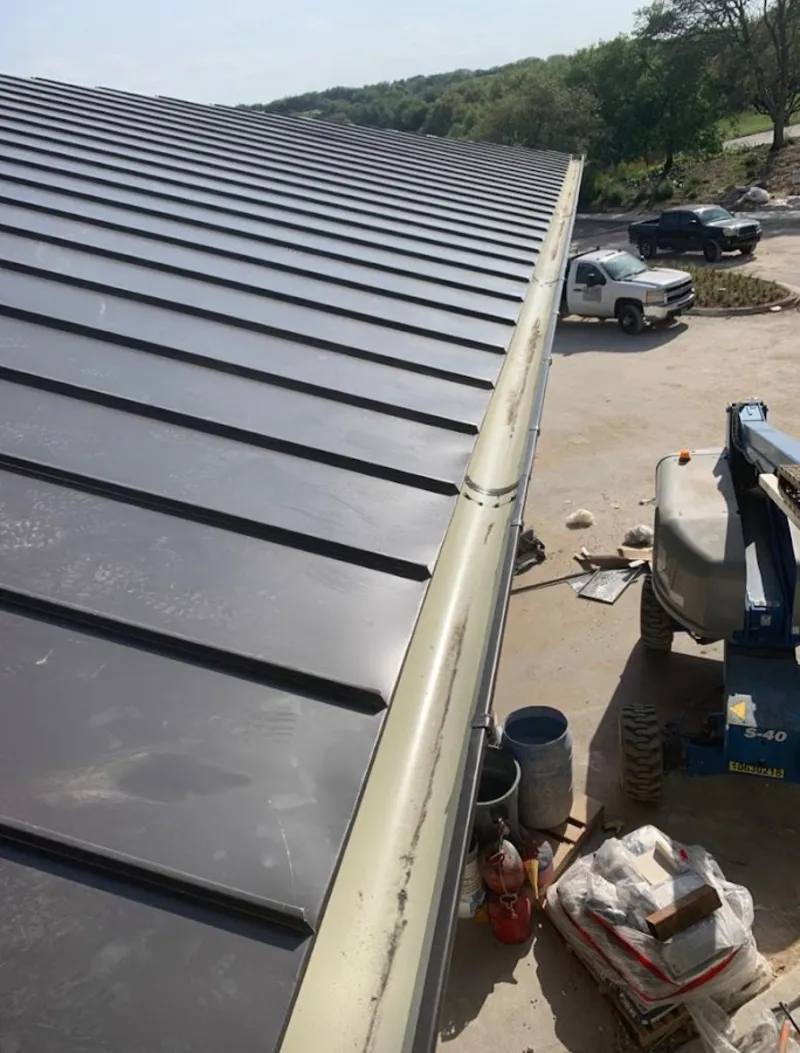 Standing seam panel and gutter detail on a metal roofing jobsite in Fargo